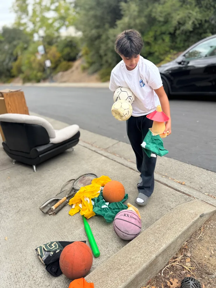 Carrying donated soccer balls and a basketball during Gear Drive #1
