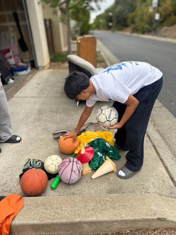 Sorting donated gear on the curb during Gear Drive #1