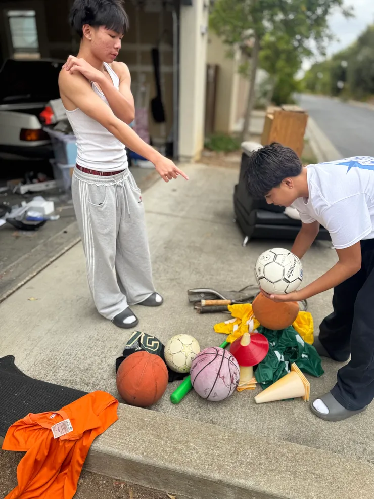 Two volunteers working together to collect donated gear