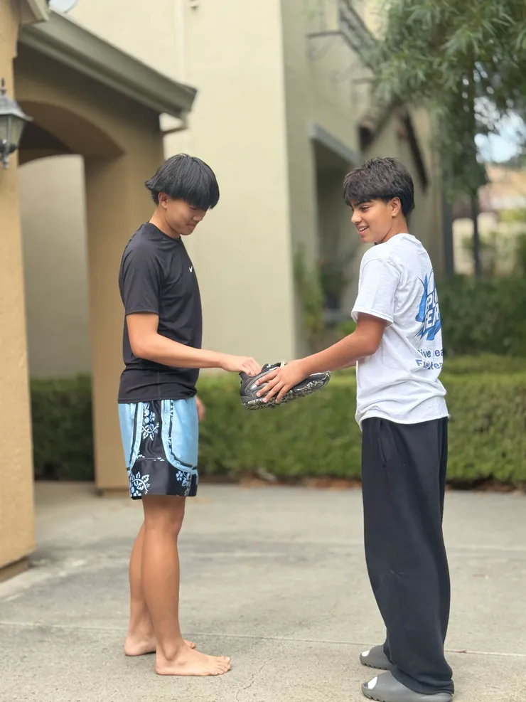 Handing off donated gear to another volunteer