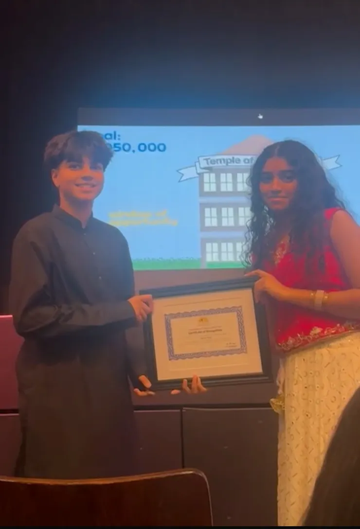 Receiving a certificate of recognition from AIM for Seva